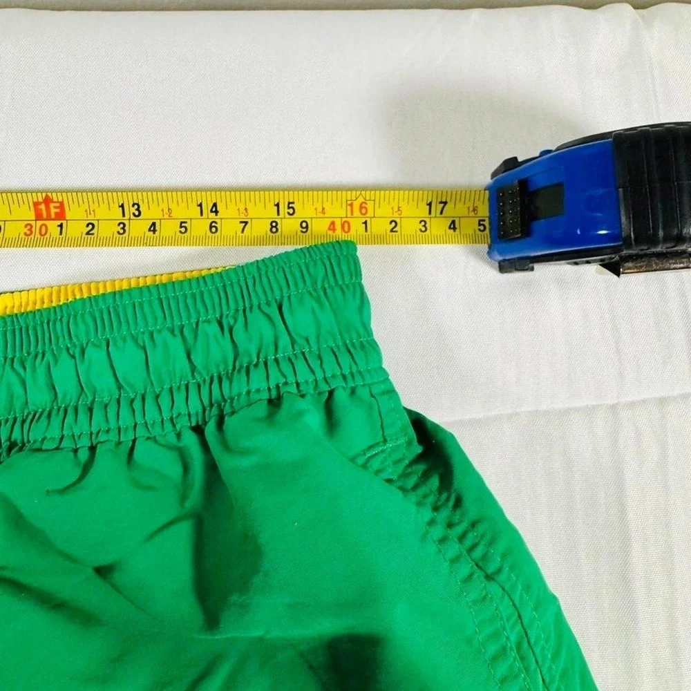 Polo Ralph Lauren green swim trunks with yellow trim.